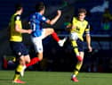 John Marquis of Portsmouth is challenged by Rob Dickie of Oxford United.