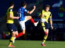 John Marquis of Portsmouth is challenged by Rob Dickie of Oxford United.