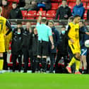 Lee Johnson is shown a red card earlier this year