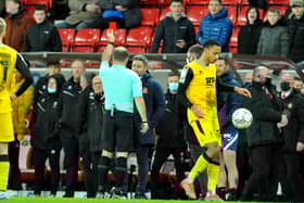 Lee Johnson is shown a red card earlier this year