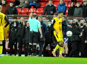Lee Johnson is shown a red card earlier this year
