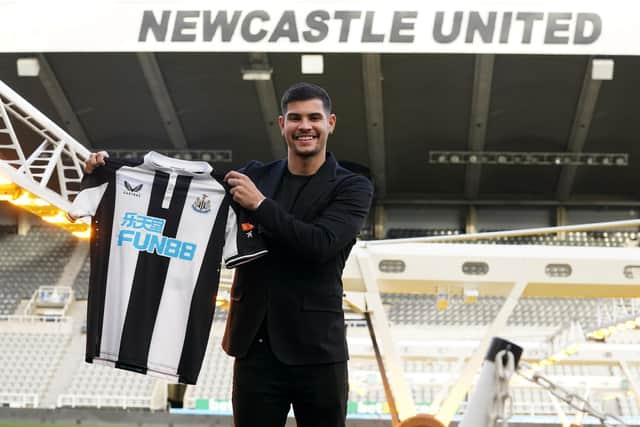 Bruno Guimaraes poses with a shirt.