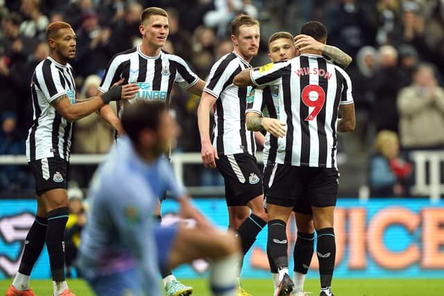 Newcastle United players celebrate after taking the lead through an Adam Smith own goal.