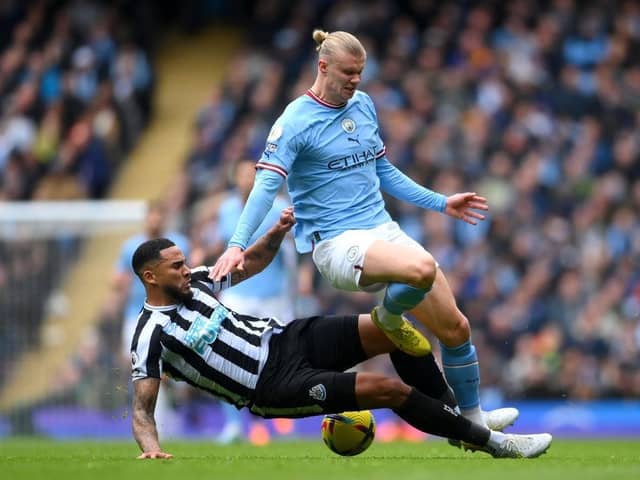 Erling Haaland of Manchester City is tackled by Jamaal Lascelles of Newcastle United during the Premier League match between Manchester City and Newcastle United at Etihad Stadium on March 04, 2023 in Manchester, England. (Photo by Laurence Griffiths/Getty Images)