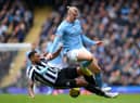 Erling Haaland of Manchester City is tackled by Jamaal Lascelles of Newcastle United during the Premier League match between Manchester City and Newcastle United at Etihad Stadium on March 04, 2023 in Manchester, England. (Photo by Laurence Griffiths/Getty Images)