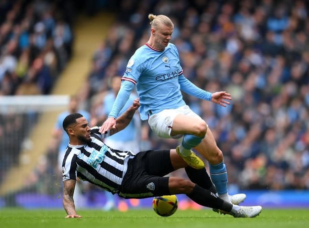 Erling Haaland of Manchester City is tackled by Jamaal Lascelles of Newcastle United during the Premier League match between Manchester City and Newcastle United at Etihad Stadium on March 04, 2023 in Manchester, England. (Photo by Laurence Griffiths/Getty Images)