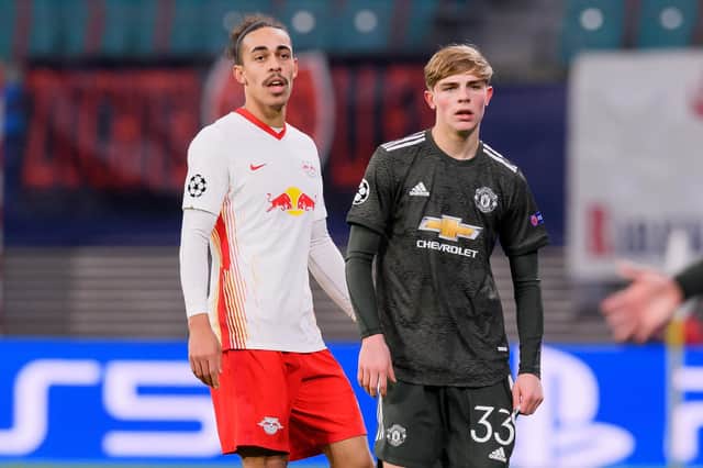 LEIPZIG, GERMANY - DECEMBER 08: (BILD ZEITUNG OUT) Yussuf Poulsen of RasenBallsport Leipzig and Brandon Williams of Manchester United look on during the UEFA Champions League Group H stage match between RB Leipzig and Manchester United at Red Bull Arena on December 8, 2020 in Leipzig, Germany. (Photo by Mario Hommes/DeFodi Images via Getty Images)