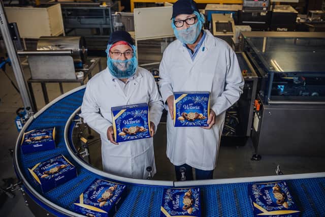 Azeem Mohammed, supply chain manager (left) and factory manager Brian Jones on the factory floor at McVitie's Wigston factory, holding some Victoria Biscuit Selection boxes (Picture: Patch Dolan/Channel 4)