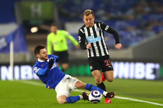 Newcastle United's Ryan Fraser (right) and Brighton and Hove Albion's Adam Lallana battle for the ball during the Premier League match at the AMEX Stadium, Brighton. Picture date: Saturday March 20, 2021.