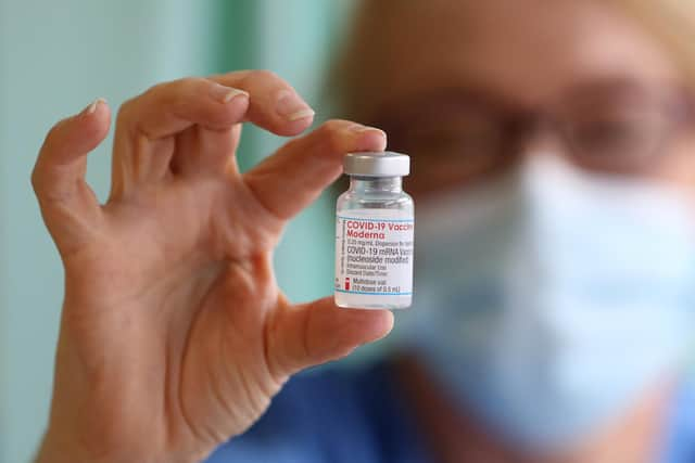 A nurse Lisa Kieh holds a vial of the Moderna Covid-19 vaccine at a vaccination centre in Wales - it is now due to be given to patients in England as the vaccination programme reaches its next stage.