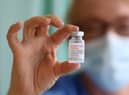 A nurse Lisa Kieh holds a vial of the Moderna Covid-19 vaccine at a vaccination centre in Wales - it is now due to be given to patients in England as the vaccination programme reaches its next stage.