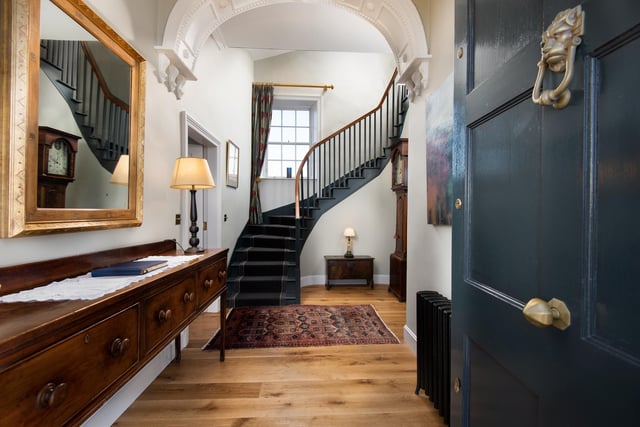 A gorgeous curved staircase leads the way to the first floor.