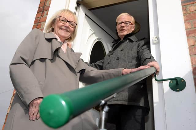 South Tyneside Council Cllr Anne Hetherington with resident Kenneth Stephenson, and the grab rail fitted to the outside of his home.