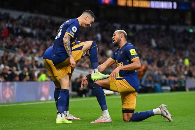 Miguel Almiron celebrates with Joelinton after scoring Newcastle United's second goal.