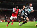 Bukayo Saka of Arsenal battles for possession with Dan Burn of Newcastle United during the Premier League match between Arsenal FC and Newcastle United at Emirates Stadium on January 03, 2023 in London, England. (Photo by Julian Finney/Getty Images)