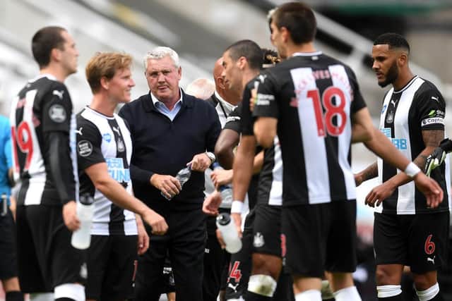 Steve Bruce, third left, speaks to his players.