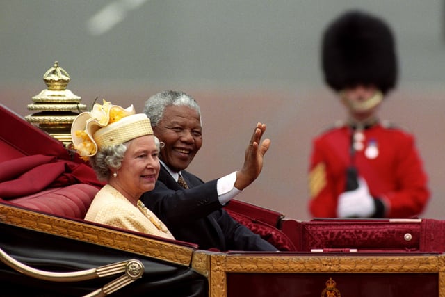 Photo dated 09/07/96 of then South African President Nelson Mandela and Queen Elizabeth II riding in a carriage along the Mall on the first full day of his state visit to the UK.