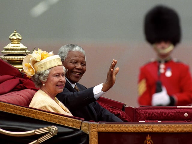 Photo dated 09/07/96 of then South African President Nelson Mandela and Queen Elizabeth II riding in a carriage along the Mall on the first full day of his state visit to the UK.