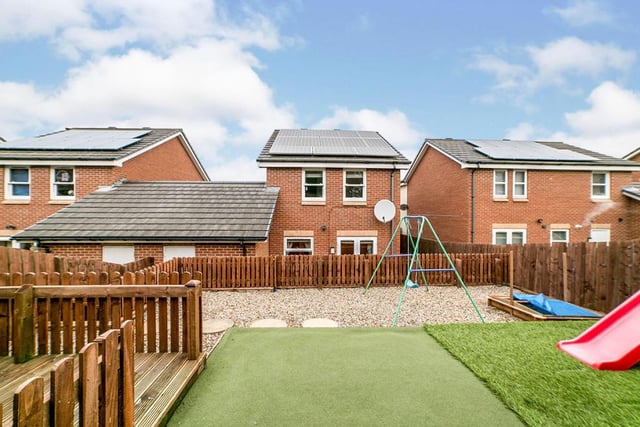 The rear garden has artificial grass and decked area, with plenty of space for the kids to play around. 

Photo: Rightmove/Duncan McCall