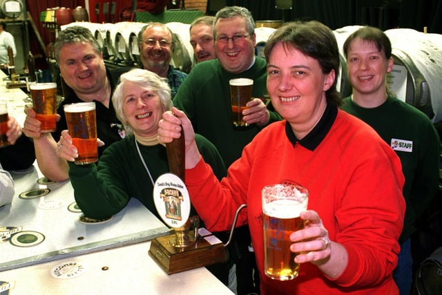 Sarah Porter pulls a pint of her own ale surrounded by members of CAMRA at the Wigan Beer Festival.