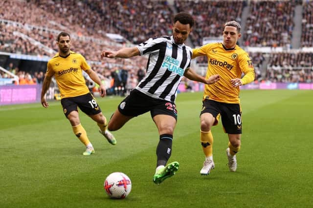 Jacob Murphy of Newcastle United runs with the ball under pressure from Daniel Podence of Wolverhampton Wanderers during the Premier League match between Newcastle United and Wolverhampton Wanderers at St. James Park on March 12, 2023 in Newcastle upon Tyne, England. (Photo by Naomi Baker/Getty Images)