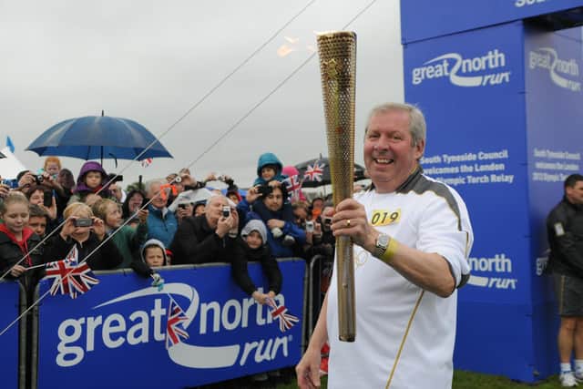 Brendan Foster carrying the Olympic torch at The Leas in South Shields in 2012