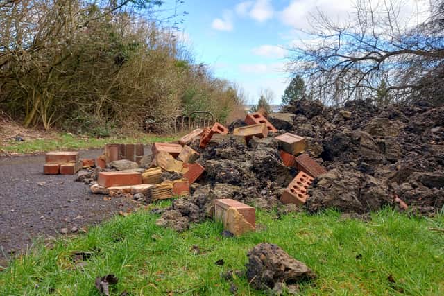 The fly-tippers dumped this rubble over the footpath.