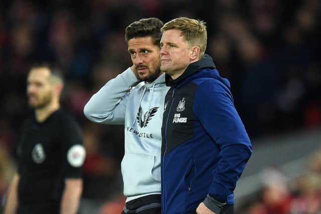Newcastle United's head coach Eddie Howe (R) and his assistant Jason Tindall (L) looks on during the English Premier League football match between Liverpool and Newcastle United at Anfield in Liverpool (Photo by OLI SCARFF/AFP via Getty Images)