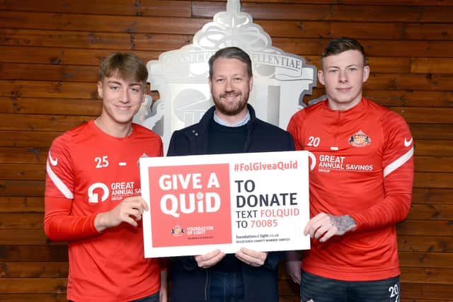SAFC players Jack Clarke and Anthony Patterson showing their support for the Foundation of Light's Give a Quid campaign alongside Great Annual Savings Group’s operations director Craig Shields.
