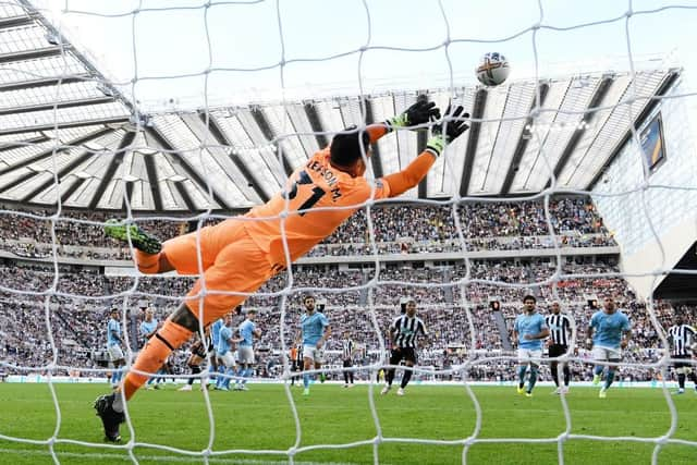 Kieran Trippier of Newcastle United scores their side's third goal from a free kick as Ederson of Manchester City attempts to make a save during the Premier League match between Newcastle United and Manchester City at St. James Park on August 21, 2022 in Newcastle upon Tyne, England. (Photo by Stu Forster/Getty Images)