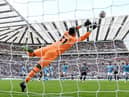 Kieran Trippier of Newcastle United scores their side's third goal from a free kick as Ederson of Manchester City attempts to make a save during the Premier League match between Newcastle United and Manchester City at St. James Park on August 21, 2022 in Newcastle upon Tyne, England. (Photo by Stu Forster/Getty Images)
