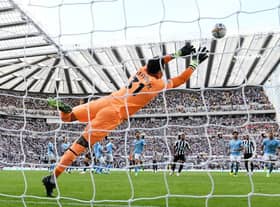 Kieran Trippier of Newcastle United scores their side's third goal from a free kick as Ederson of Manchester City attempts to make a save during the Premier League match between Newcastle United and Manchester City at St. James Park on August 21, 2022 in Newcastle upon Tyne, England. (Photo by Stu Forster/Getty Images)