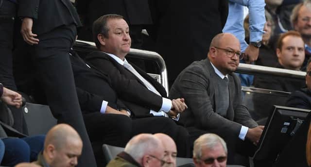Newcastle owner Mike Ashley (l) flanked by  Lee Charnley look on from the stand during the Premier League match between Newcastle United and Leicester City at St. James Park on September 29, 2018 in Newcastle upon Tyne, United Kingdom.