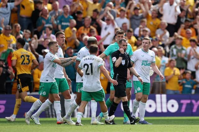 Kieran Trippier of Newcastle United protests to Referee Peter Bankes after Raul Jimenez of Wolverhampton Wanderers (not in picture) scores a goal which is later disallowed after a VAR review during the Premier League match between Wolverhampton Wanderers and Newcastle United at Molineux on August 28, 2022 in Wolverhampton, England. (Photo by Eddie Keogh/Getty Images)