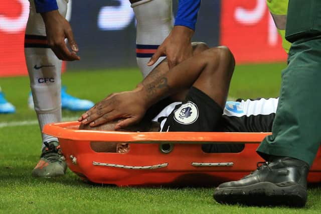 Newcastle United's Dutch defender Jetro Willems reacts as he is stretchered off injured during the English Premier League football match between Newcastle United and Chelsea at St James' Park in Newcastle-upon-Tyne, north east England on January 18, 2020.