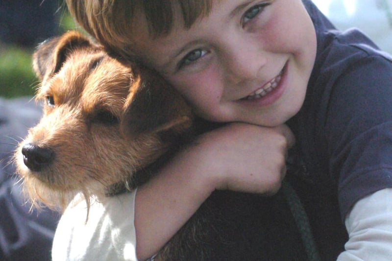Daniel Royston, five, gave his  mongrel terrier 'Pip' a hug before entering him in the Penistone dog show in 2004