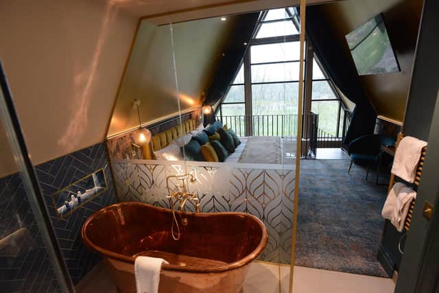 The en-suite has a free-standing copper bath
