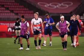 KASHIMA, JAPAN - JULY 30: Demi Stokes #3, Millie Bright #14 and Kim Little #8 of Team Great Britain look dejected after the Women's Quarter Final match between Great Britain and Australia on day seven of the Tokyo 2020 Olympic Games at Kashima Stadium on July 30, 2021 in Kashima, Ibaraki, Japan. (Photo by Atsushi Tomura/Getty Images)