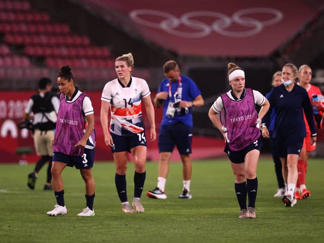 KASHIMA, JAPAN - JULY 30: Demi Stokes #3, Millie Bright #14 and Kim Little #8 of Team Great Britain look dejected after the Women's Quarter Final match between Great Britain and Australia on day seven of the Tokyo 2020 Olympic Games at Kashima Stadium on July 30, 2021 in Kashima, Ibaraki, Japan. (Photo by Atsushi Tomura/Getty Images)