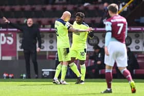 Allan Saint-Maximin of Newcastle United celebrates with Jonjo Shelvey after scoring their side's second goal during the Premier League match between Burnley and Newcastle United at Turf Moor on April 11, 2021 in Burnley, England.