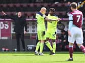 Allan Saint-Maximin of Newcastle United celebrates with Jonjo Shelvey after scoring their side's second goal during the Premier League match between Burnley and Newcastle United at Turf Moor on April 11, 2021 in Burnley, England.