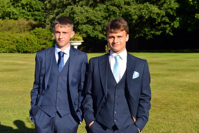 Two Year 11 boys pose in their blue suits.