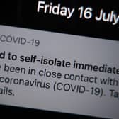 A notification issued by the NHS coronavirus contact tracing app - informing a person of the need to self-isolate immediately, due to having been in close contact with someone who has coronavirus - is displayed on a mobile phone in London, during the easing of lockdown restrictions in England. Picture date: Friday July 16, 2021.