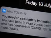 A notification issued by the NHS coronavirus contact tracing app - informing a person of the need to self-isolate immediately, due to having been in close contact with someone who has coronavirus - is displayed on a mobile phone in London, during the easing of lockdown restrictions in England. Picture date: Friday July 16, 2021.