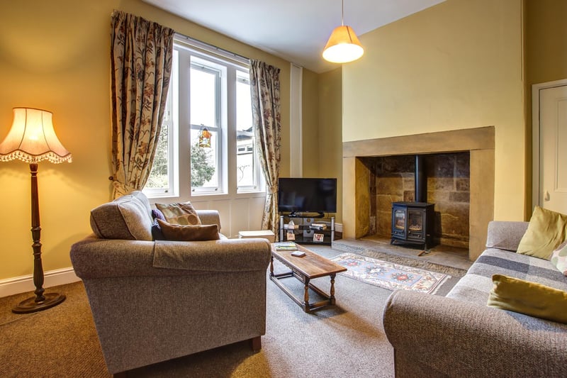 A cosy family snug room with inglenook fireplace.