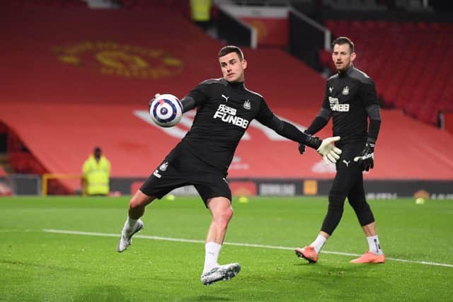 Newcastle United's English goalkeeper Karl Darlow (L) and Newcastle United's Slovakian goalkeeper Martin Dubravka (R) warm up ahead of the English Premier League football match between Manchester United and Newcastle at Old Trafford in Manchester, north west England, on February 21, 2021.