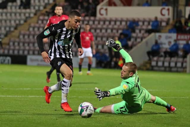Newcastle United's Paraguayan midfielder Miguel Almiron (L) goes around Morecambe's Englsish goalkeeper Mark Halstead on his way to scoring their second goal during the English League Cup third round football match between Morecambe and Newcastle United at The Mazuma Stadium in north-west England, on September 23, 2020.