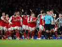 Arsenal players surround the Referee Andy Madley after a late penalty appeal (Photo by Julian Finney/Getty Images)