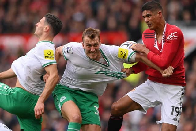 Manchester United's Raphael Varane of Newcastle United's Dan Burn.