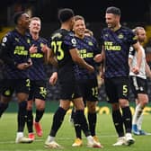 Fabian Schar of Newcastle United celebrates with team mates Dwight Gayle, Joe Willock and Jacob Murphy after scoring his team's second goal during the Premier League match between Fulham and Newcastle United at Craven Cottage on May 23, 2021 in London, England.